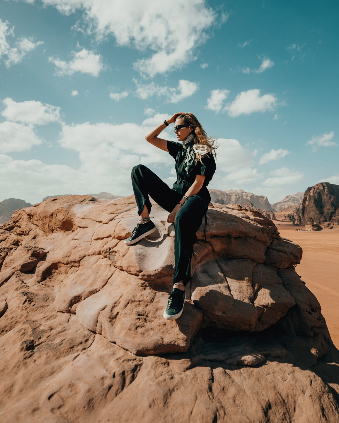 Stylish female traveler enjoying rocky terrain